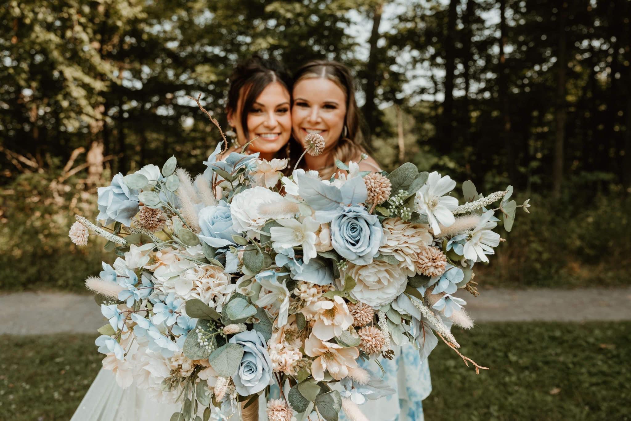 bride and bridesmaids holding blue and white bouquets
