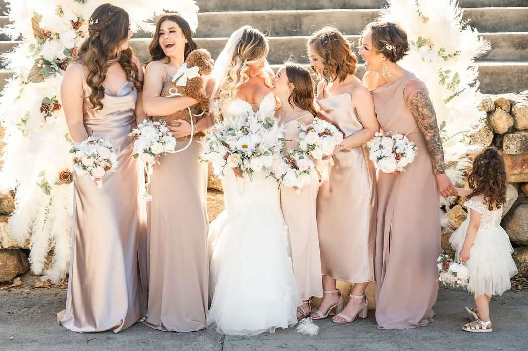 bride with bridesmaids holding elegant white bouquets