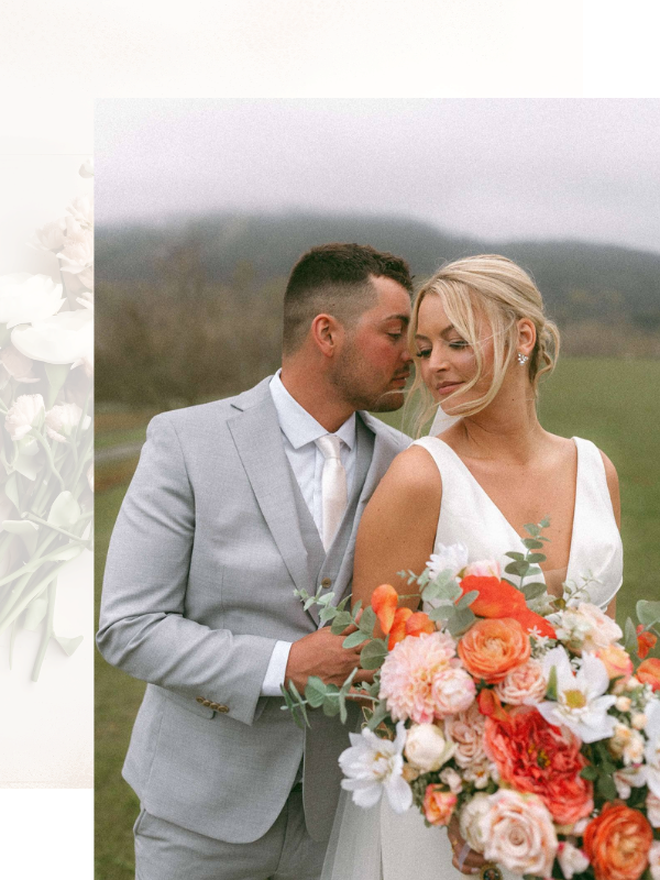 groom embracing bride holding a colorful wedding bouquet